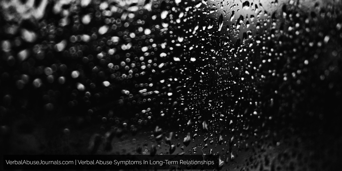 rain on a window in black and white showing the feeling of verbal abuse symptoms in long-term relationships