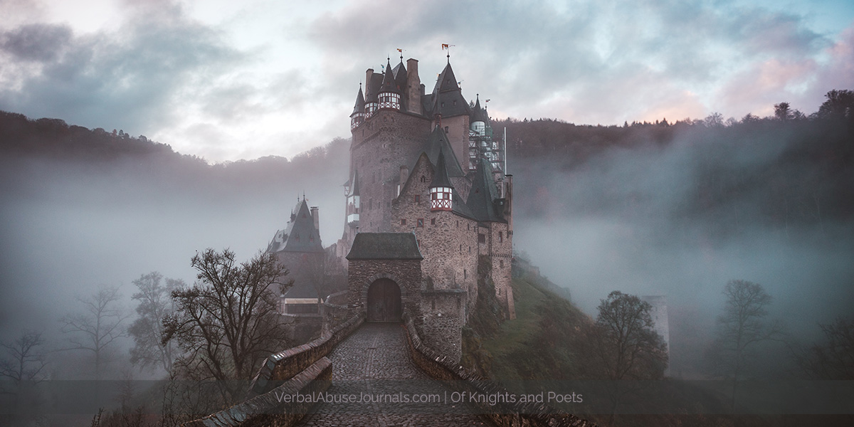 A castle, possibly a German castle, sitting atop a hill surrounded by fog. A castle where you can imagine a knight or a poet living.