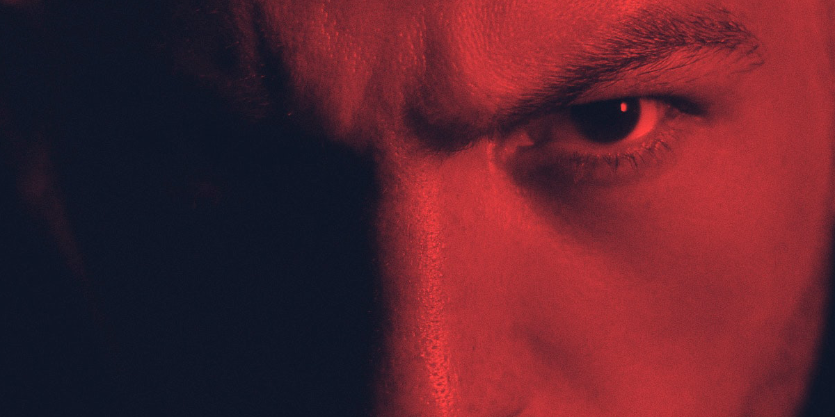 angry man's eyes, one in shadow