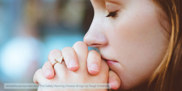 Thoughtful woman puts her head on her hands as she contemplates the safety planning process.